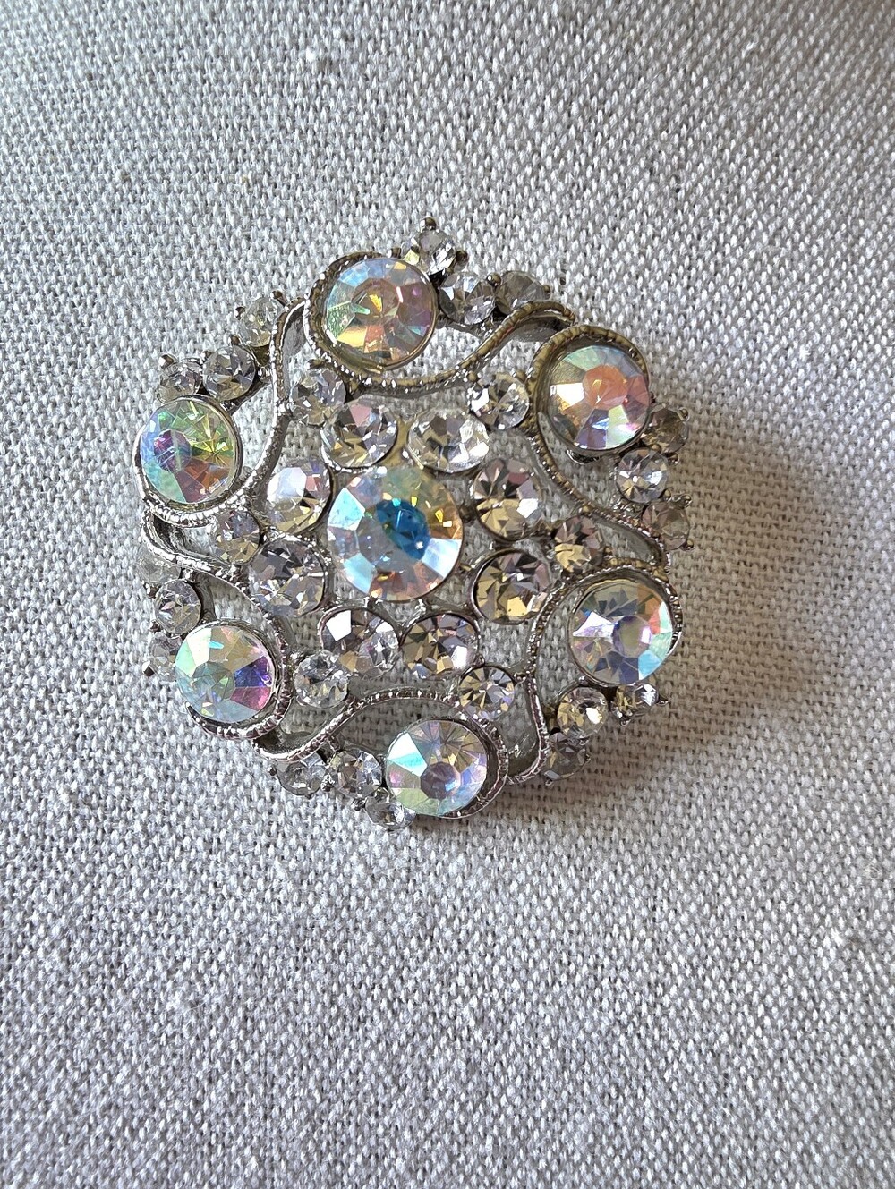 Vintage silver-toned brooch featuring Aurora Borealis crystals and rhinestones